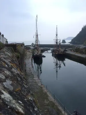 two boats are docked in a body of water at Quay Courtyard, on the harbour with free parking in Charlestown