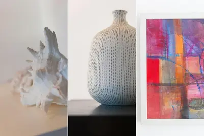 a white vase sitting on a table next to a painting at Sea Crest in St Ives