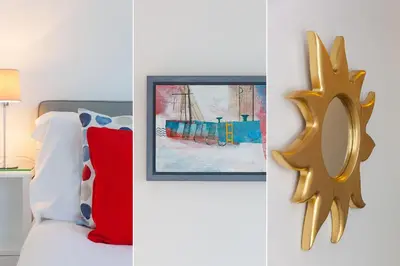 a bedroom with a bed and a painting of a ship at Sea Crest in St Ives