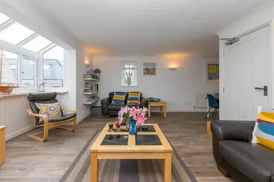 a living room with a couch and a table at Number One - Stones Court in St Ives