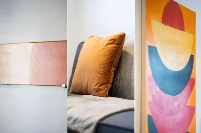 two pictures of a couch with a pillow and a painting at Number One - Stones Court in St Ives