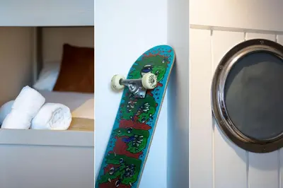 a skateboard hanging on a wall next to a mirror at Number One - Stones Court in St Ives