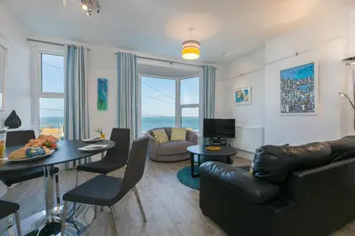 a living room with a couch and a table at SeaCrest 2 in St Ives