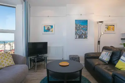 a living room with a couch and a table at SeaCrest 2 in St Ives