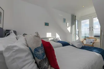 a bedroom with two beds and a window at SeaCrest 2 in St Ives