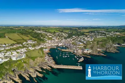 an aerial view of a harbor with boats in the water at Marine Point, Mevagissey - sensational cliff top views of harbour and bay in Mevagissey