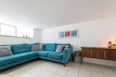 a blue couch sitting in a living room at Mariner's Belle in St Ives