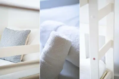 a white bunk bed with towels and pillows at Shrimp Cottage in St Ives