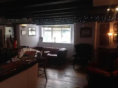 a bar with chairs and a table and a window at The Safe Harbour Hotel in Fowey