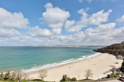 a view of a beach with people in the water at 35 Carrack Widden in St Ives