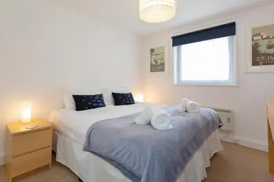 a bedroom with two beds with towels on them at 35 Carrack Widden in St Ives