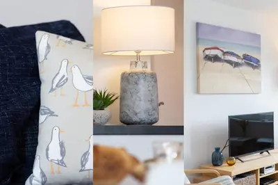 a living room with a lamp and a bed and a tv at 35 Carrack Widden in St Ives