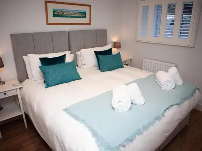 a bedroom with a large bed with towels on it at 3 Sunday School Court in St Ives