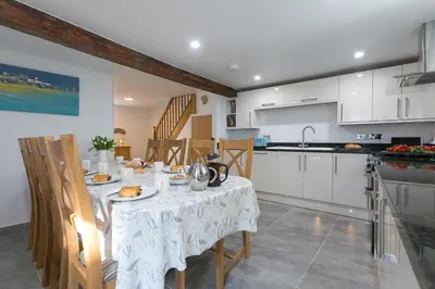 a kitchen with a table with a plate of food on it at Maranatha in St Ives