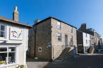 an old brick building in a street at Maranatha in St Ives