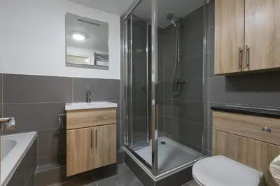 a bathroom with a shower and a toilet and a sink at Maranatha in St Ives