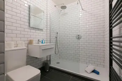 a white bathroom with a toilet and a sink at 21 Carthew Court in St Ives