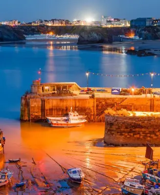 a harbor with boats in the water at night at Harrington Flats in Newquay