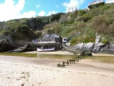 a beach with a row of benches on the sand at Harrington Flats in Newquay