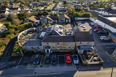 an aerial view of a large house with cars parked in a parking lot at The Victoria Inn in Truro