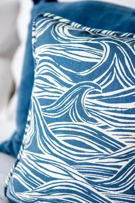 a blue pillow with white waves on it at Seafarers, Mevagissey - Coastguard Cottage overlooking harbour in Mevagissey