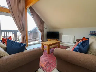 a living room with two couches and a television at Lodge Sixty Six in Saint Columb Major