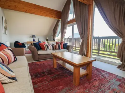 a living room with a couch and a coffee table at Lodge Sixty Six in Saint Columb Major