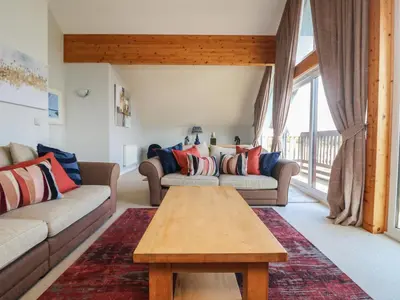 a living room with two couches and a coffee table at Lodge Sixty Six in Saint Columb Major