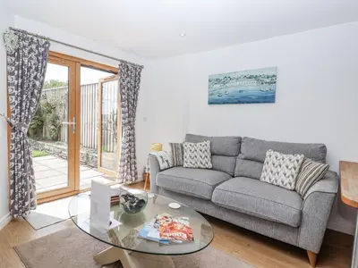 a living room with a couch and a glass table at Whitsand in Saltash