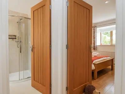a bathroom with a shower and a glass door at Whitsand in Saltash
