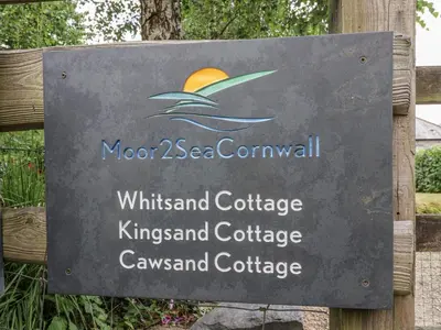 a sign for the winds island cottage kingsland cottageconservancy at Whitsand in Saltash