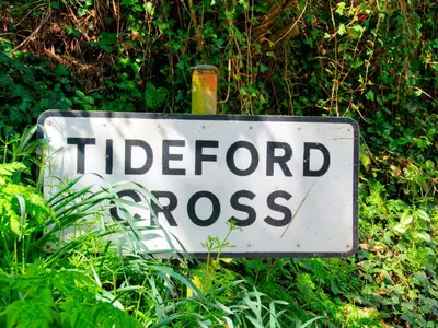 a sign for a hidden cross in the grass at Whitsand in Saltash