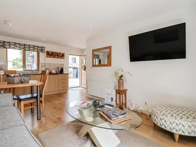a living room with a couch and a table at Whitsand in Saltash