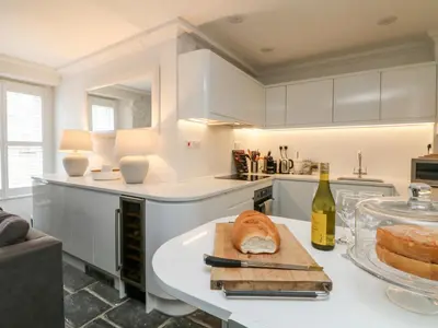 a kitchen with a table with a loaf of bread on it at Rock House in Tintagel