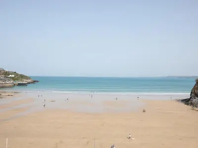 a group of people on a beach near the ocean at Onshore 6 - Newquay Towan Beach View in Newquay