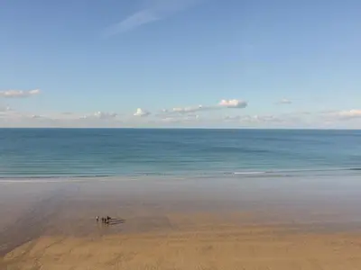 a group of people standing on a beach at Onshore 6 - Newquay Towan Beach View in Newquay