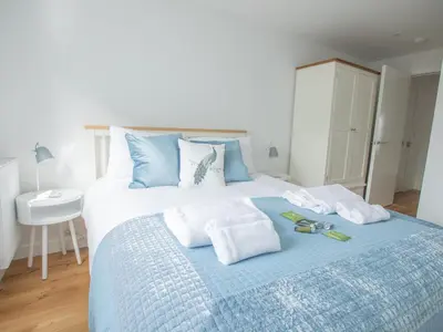 a bedroom with a bed with towels on it at Onshore 6 - Newquay Towan Beach View in Newquay