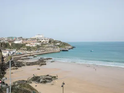 a beach with people on the sand and the ocean at Onshore 6 - Newquay Towan Beach View in Newquay