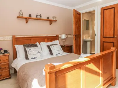 a bedroom with a large bed with a wooden frame at Speedwell in Charlestown