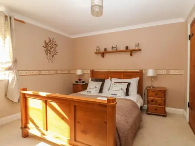 a bedroom with a wooden bed with pillows at Speedwell in Charlestown
