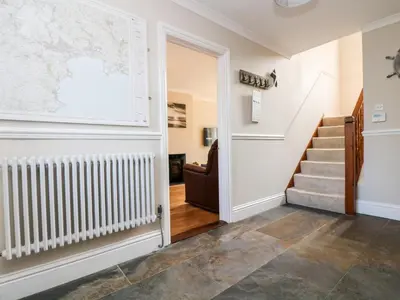 a hallway with stairs and a map on the wall at Speedwell in Charlestown