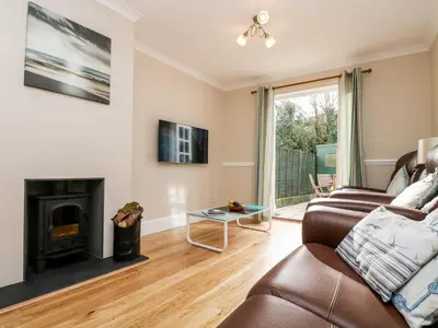 a living room with a couch and a fireplace at Speedwell in Charlestown
