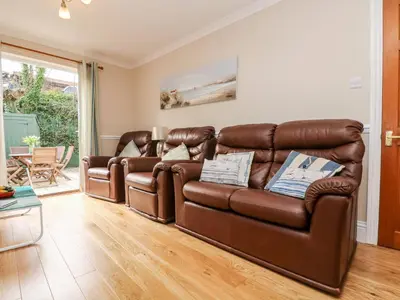 a living room with a brown leather couch at Speedwell in Charlestown