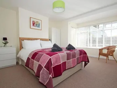 a bedroom with a bed with a purple blanket at Seagrass in Newquay