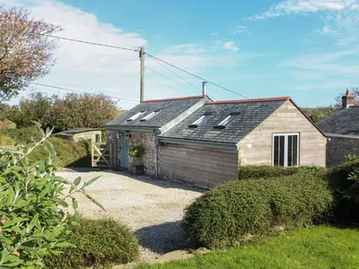 a house with solar panels on the roof at Hay Loft in Camborne