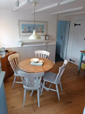a dining room with a table and chairs at Hillside Cottage in Wadebridge