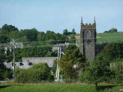 a church with a tower with a clock on it at Hillside Cottage in Wadebridge