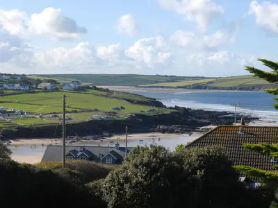 a view of a beach with houses and the ocean at Bishops View in Polzeath