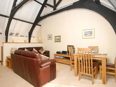 a living room with a couch and a table at Bishops View in Polzeath
