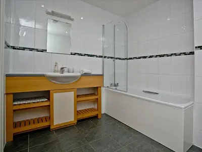 a bathroom with a sink and a bath tub and a sink at Fistral View At Bredon Court in Newquay